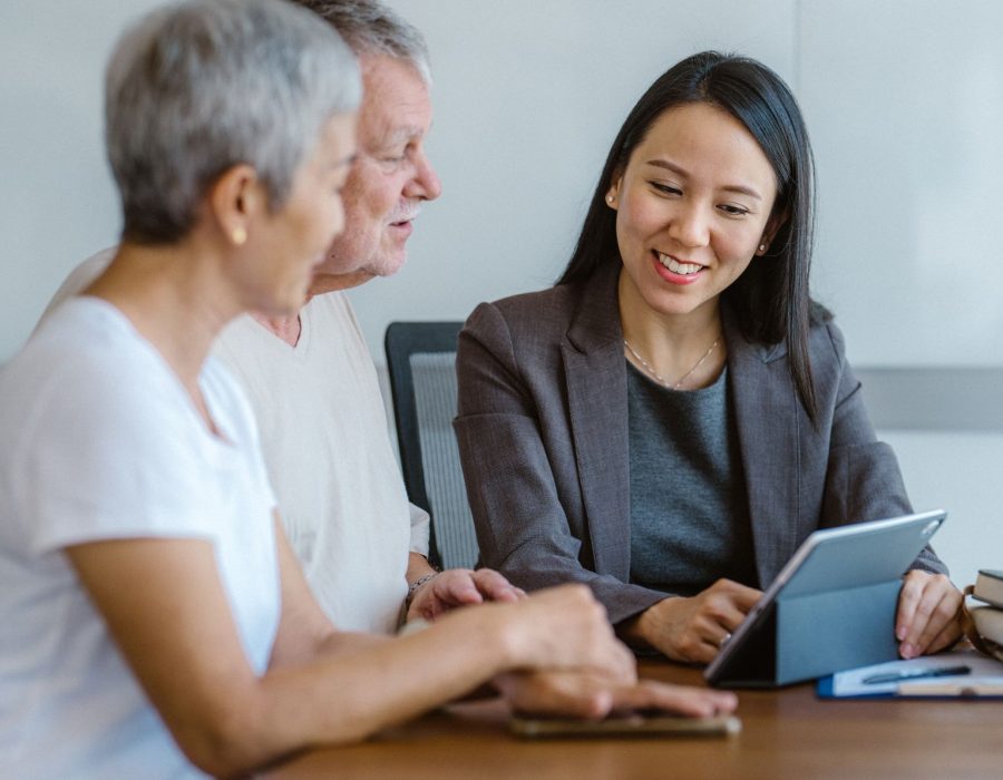 A multiethnic senior couple is signing a business agent agreement with an estate investment consultant during a meeting. - Real estate x Client consultation in Southeast Asia Concept.
